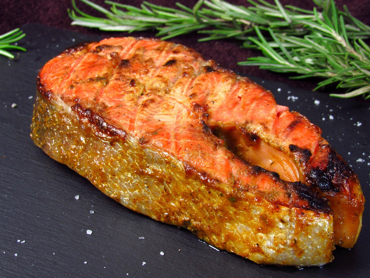 A healthy plated dinner featuring cooked salmon and vegetables