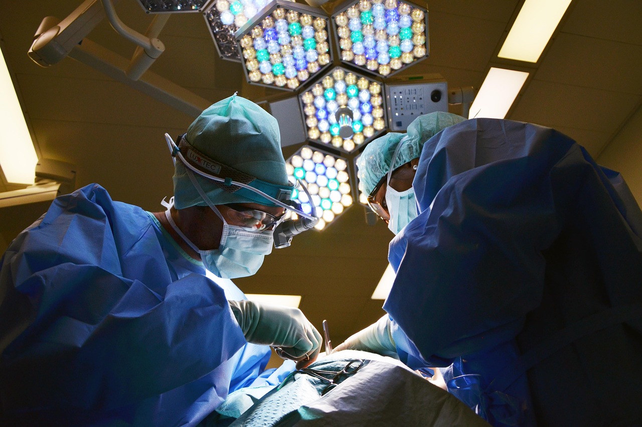 A medical doctor studying a joint X-ray on a light board