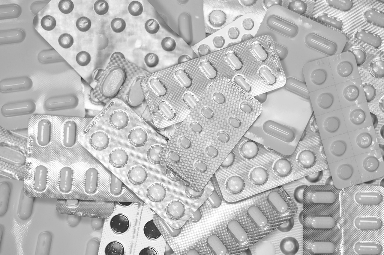Pharmacist holding medications in a pharmacy