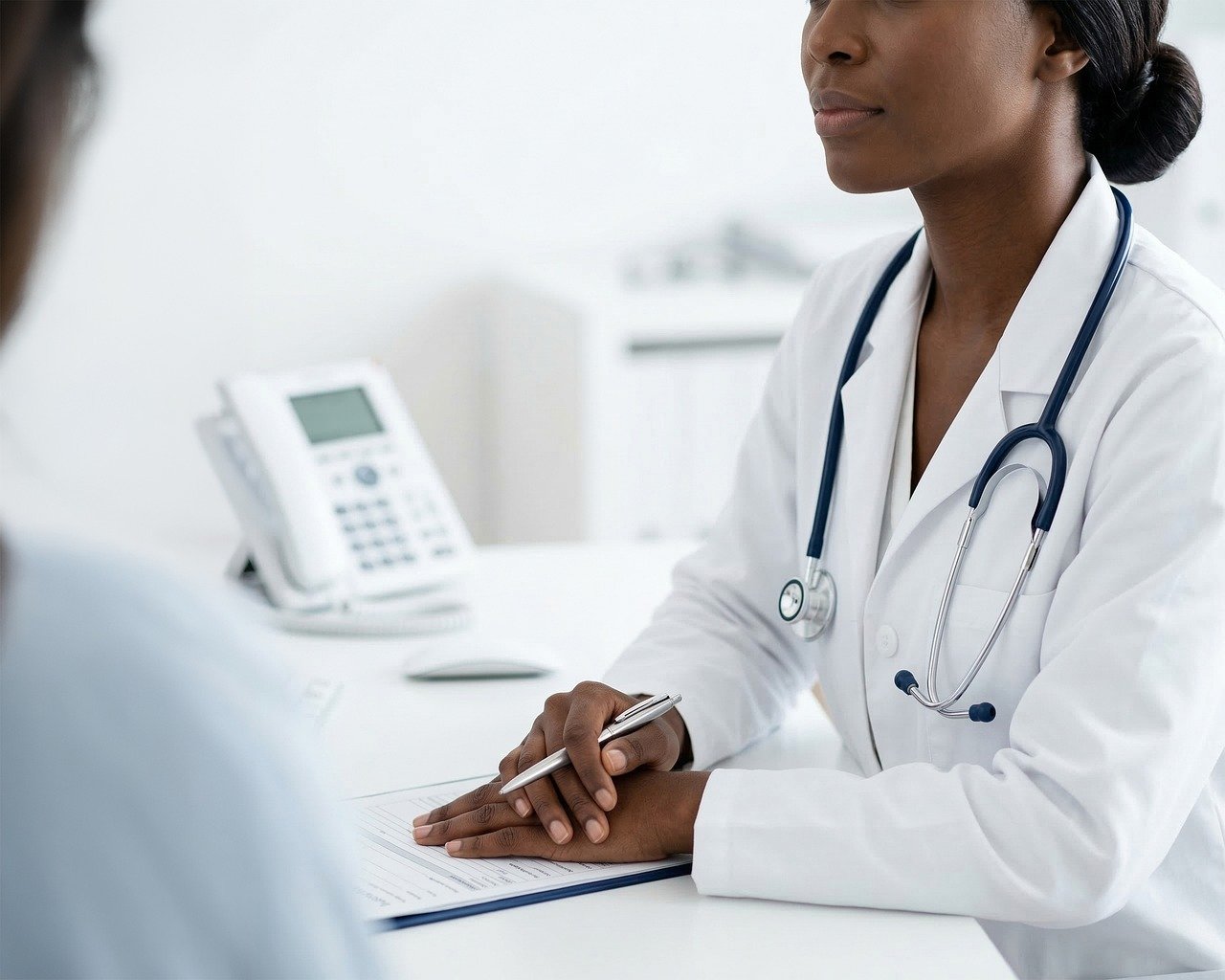 Doctor consultation at a desk in a clinic